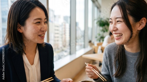 Two Women Enjoying Lunch Together in Modern Restaurant Setting