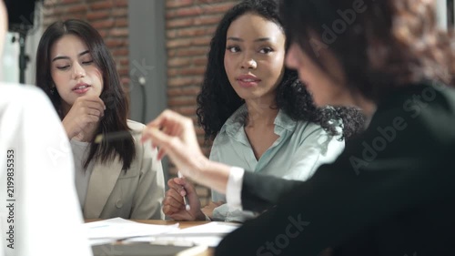 Diverse businesswomen discussing ideas during team meeting in modern office, teamwork, collaboration, communication, project planning, corporate strategy and professional workplace.