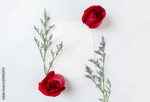 Blank paper card mockup and red roses with lower on white background. Valentine or wedding day.