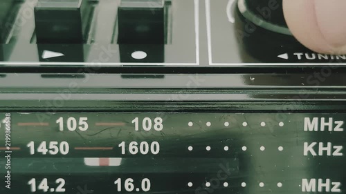 Searching for radio stations on an old radio recorder in a familiar setting