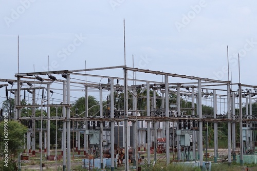 High Voltage Electrical Substation with Power Transmission Equipment in a Rural South Indian Landscape.