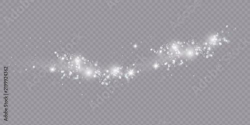 The dust sparks and golden stars shine with special light. Vector sparkles on a transparent background. Christmas light effect.