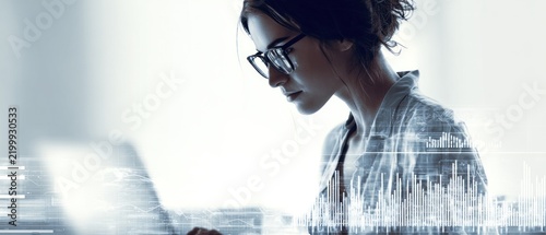 Woman working on laptop with data overlay