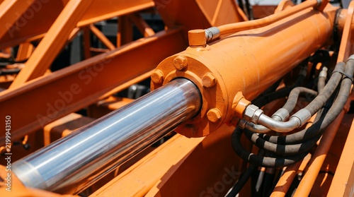 Close-up of an industrial hydraulic cylinder in action