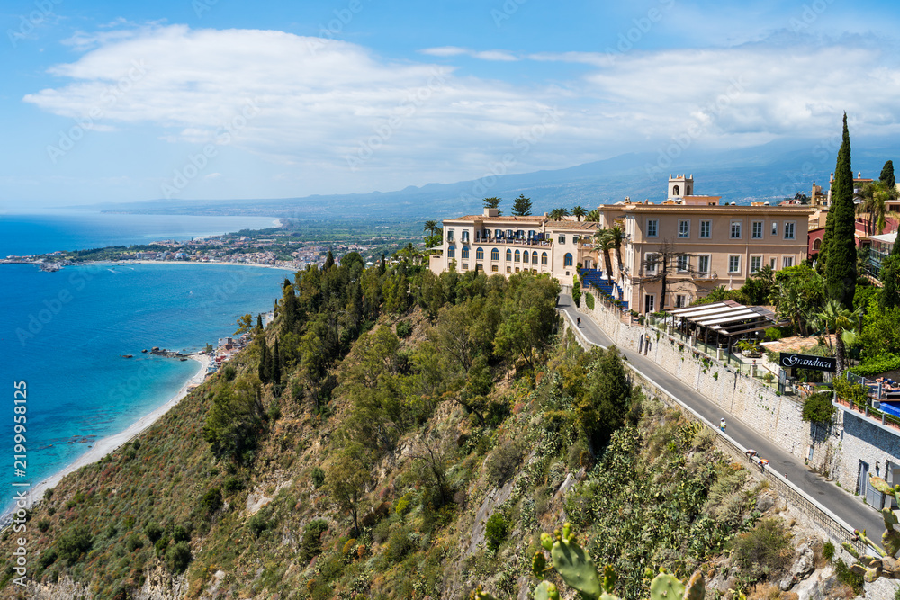 Fototapeta premium Taormina cliffside town and sea views with winding coastal road