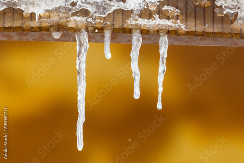 Icicles hang from a wooden eave