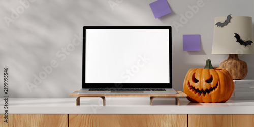 3D rendering of Laptop Mockup on Desk Riser with Halloween Pumpkin and Bat Decor