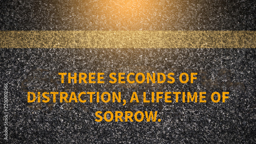 Fotografie Distracted driving warning slogan on dark asphalt road with yellow line: Three s