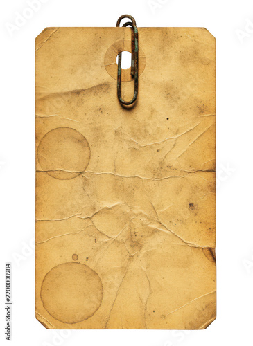 Rectangular vintage paper tag with a rusty metal paperclip attached, showing circular stains and a heavily creased texture on white background isolated on a transparent background