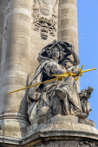Statue la france de charlemagne with golden sword on pont alexandre iii in paris