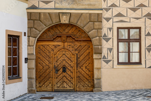 Historic Renaissance Wooden Portal with Sgraffito Facade and Stone Arch