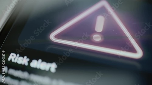 Risk alert screen presents prominent warning symbol