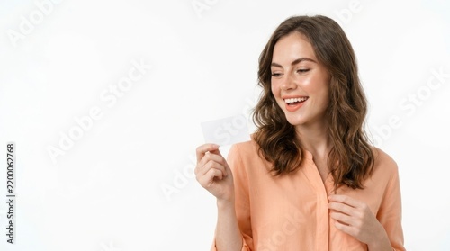 Happy woman holding blank card smiling.