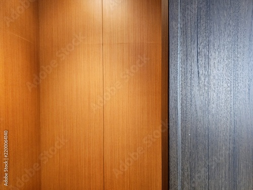 Modern interior wall paneling featuring natural wood grain and dark wood texture.