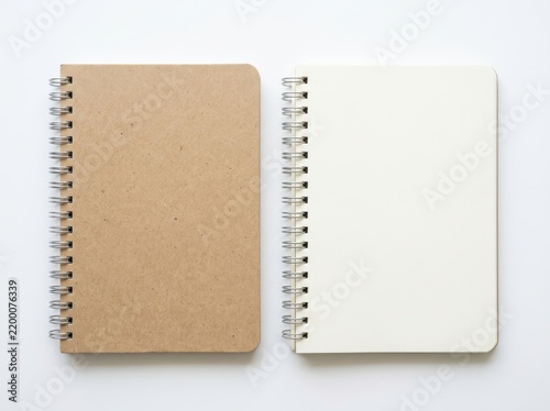 Two open spiral notebooks with blank pages isolated on white background