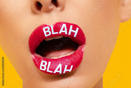 Woman mouth close up on vivid background with BLAH BLAH text