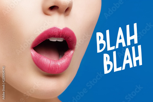 Woman mouth close up on vivid background with BLAH BLAH text