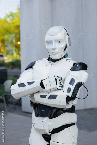 Futuristic android standing with arms crossed