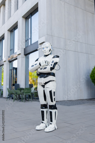 Full length white android standing with arms crossed