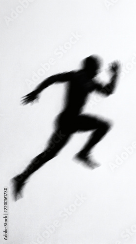 Motion blur silhouette of a person running fast on white background