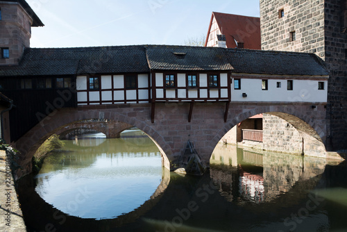 Bridge with timbered houses over the river with stone arches, Nuremberg, Germany.