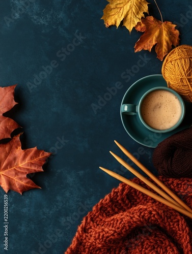 Autumn knitting flat lay with coffee, yarn and maple leaves