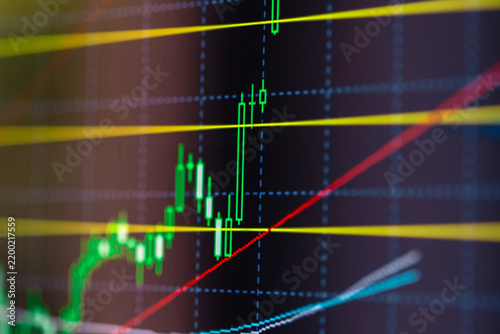 Rising candlestick chart on screen. Trading data and financial market movement.