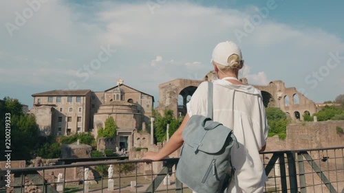 Woman with Backpack Overlooking Roman Forum Ruins in Rome