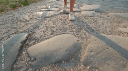 Feet Walking Across Ancient Roman Forum Stones at Sunset