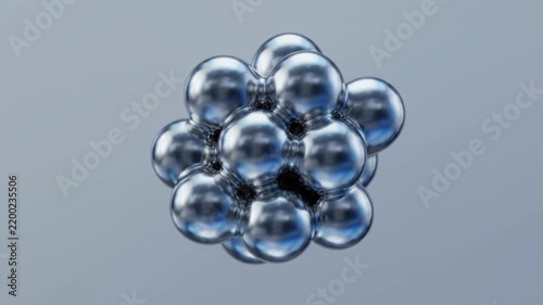 Abstract Scientific Animation of Metallic Spheres Multiplying and Clustering into a Molecular Structure.