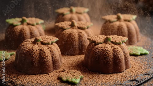 Cocoa Powder Sifted Over Chocolate Pumpkin Sweets Shaped Like Autumn Pumpkins, Close Up Macro Food Video