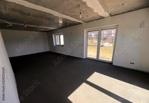 A room with dark grey cement screed floor. Freshly poured floor in a new residential building house 