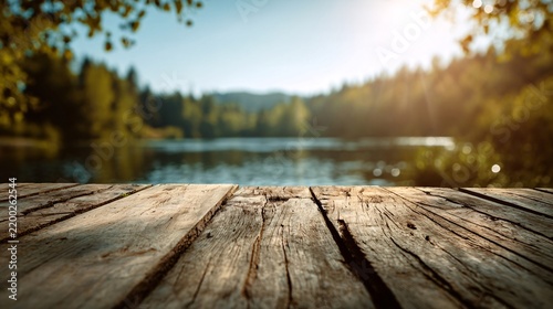 Weathered wooden planks forming a rustic surface overlooking a calm lake at golden hour