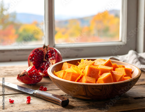 Cozy kitchen still life with pumpkin slices on rustic wooden table for web banner.