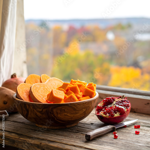 Cozy kitchen still life with pumpkin slices on rustic wooden table for web banner.