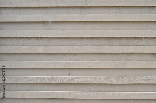 Fotografie Tan painted wood partition fence surface with alternating protruding and recesse