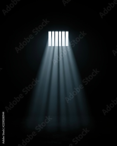 Bright light beams streaming through dark prison cell window bars creating a moody atmosphere. Symbolic representation of imprisonment or hope.
