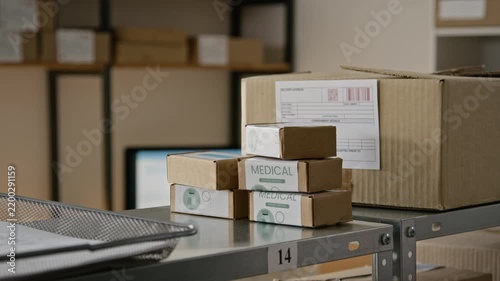 Stacked medical packages resting on metal rack in distribution warehouse. Ideal for pharmaceutical logistics, e-commerce supply chain, and medicine delivery marketing