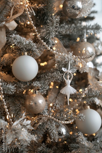 Christmas Tree With Silver and White Ornaments and a Ballerina Decoration