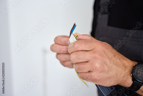 Man preparing electrical wires for installation