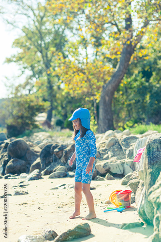 Carefree Little Girl Playing with Beach Toys on a Sunny Beach