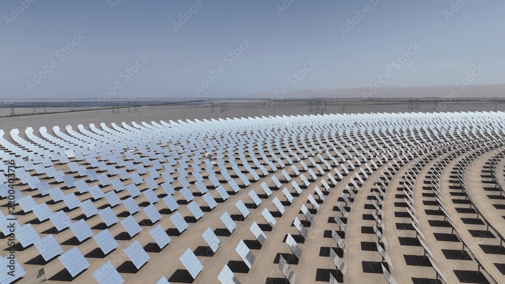 Fototapeta premium Large scale tower solar thermal power station mirror field in desert
