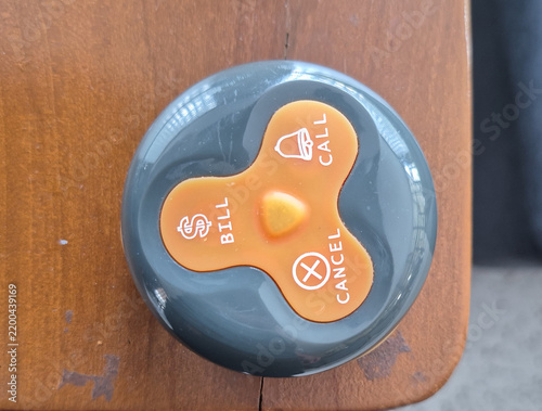 Foto Wireless Waiter Call Button on Wooden Table for Restaurant Service and Customer