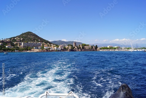 Historic castle on Mediterranean coast seen from a boat