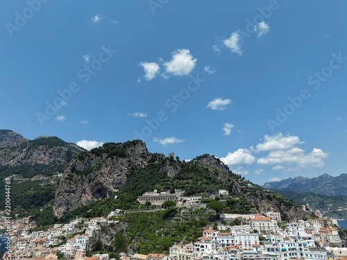aerial view of Amalfi Harbour and beach front pleasure boats and yacht parked in the blue water of the Tyrrhenian Sea part of the larger Mediterranean Sea
