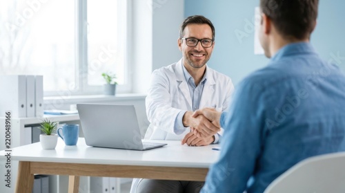 Male doctor shaking hands with a patient in a bright modern medical office clinic