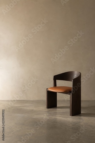 Modern minimalist dark-stained wooden chair with tan leather seat in neutral-toned studio, clean industrial interior design, contemporary furniture style