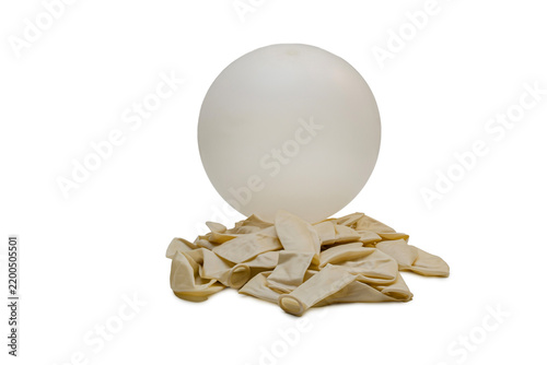 Inflated White Latex Balloon Resting on Deflated Rubber Balloons Isolated on White Background