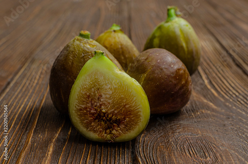 Fresh Ripe Fig Cut in Half on Dark Wooden Background