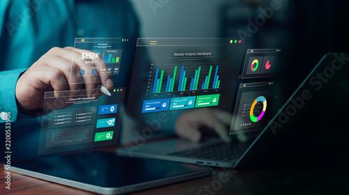 Business analyst interacting with modern financial data dashboard and KPI metrics on a futuristic digital screen